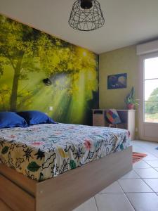 a bedroom with a bed with a painting on the wall at chambre avec SDB privative en pleine campagne in Baillou