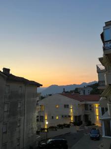 a sunset view of a city with buildings at Apartman Nina in Kotor