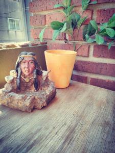 a statue of a woman sitting on top of a table at Virxen do Carmen 7 alojamiento in Puentecesures