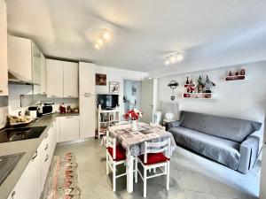 a kitchen and living room with a table and a couch at Ca d'Ada in Tolmezzo