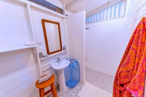 a bathroom with a sink and a toilet and a mirror at Casa Theia - Comfort cabin, Caribbean jungle beach in Puerto Viejo