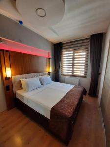 A bed or beds in a room at KB Apart Otel