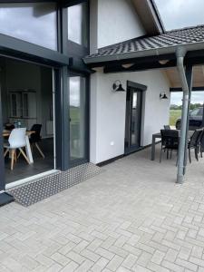 a patio with glass doors and a table and chairs at Ferienhaus G32 in Butjadingen