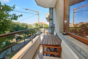 a balcony with a wooden bench on the side of a building at Apartment Knjaz Boris in Pomorie