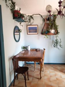 a dining room with a wooden table and chairs at Ca l'Anna i l'Antonino in Maldá