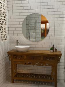 a bathroom with a sink and a mirror at The Hideaway Canggu in Canggu