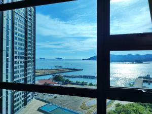 a view of the ocean from a window at Lovely Seaview Condo TII @ Jesselton Quay in Kota Kinabalu