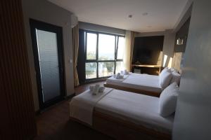 Postel nebo postele na pokoji v ubytování Taşliman Otel