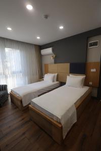 Postel nebo postele na pokoji v ubytování Taşliman Otel