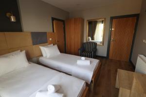 Postel nebo postele na pokoji v ubytování Taşliman Otel