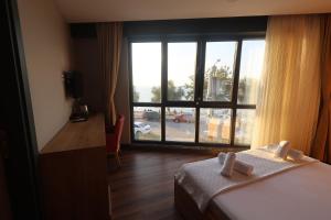 Postel nebo postele na pokoji v ubytování Taşliman Otel