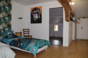 a bedroom with a bed and a painting of a dog at LES 2 CHENES in Les Riffes