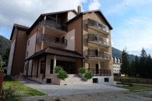 a large building with stairs in front of it at Marmot apartment up & down in Poiana Brasov