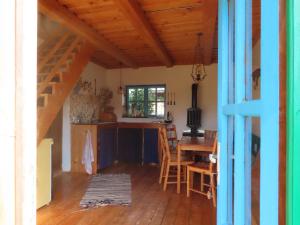 a kitchen and dining room with a staircase in a house at Babou Maramures in Breb