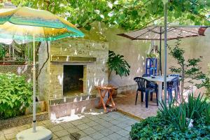 a patio with a table and an umbrella at Apartment Dora in Pomorie