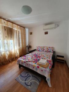 a small bedroom with a bed and a rug at La Turturica in Corbu +5 photos