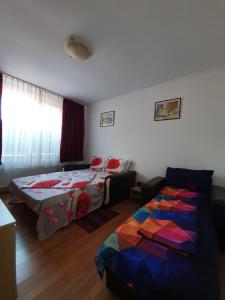 a bedroom with a bed and a couch in it at La Turturica in Corbu