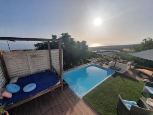 a swimming pool on a deck with a view of the ocean at Casa de Campo Lomo del Balo in Guía de Isora