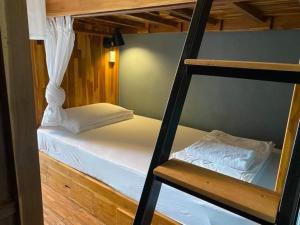 a couple of bunk beds in a room at Bloom Cafe & Hostel in Ko Lipe