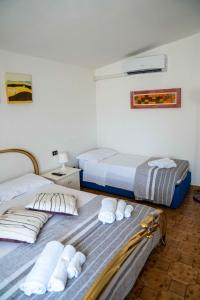 グリゾリーアにあるQueen's Bed & Breakfastのタオル付きのドミトリールームのベッド2台