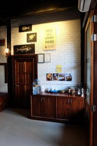 a room with a counter and a brick wall at Bloom Cafe & Hostel in Ko Lipe