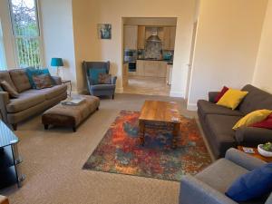 a living room with couches and a coffee table at The Shelbourne in Southport