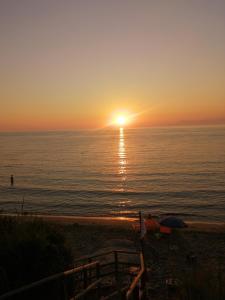 a sunset on the beach with the sun setting at La Vecchia Taverna B&B in Prignano Cilento