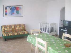 a living room with a table and a couch and a tv at Ariabuona in Moneglia