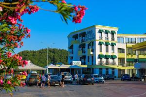 a town with cars parked in front of a building at LORD Hotel Tirana in Tirana