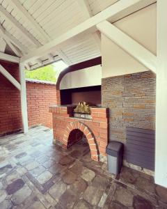 a brick oven in a patio with a roof at La Casa Tamaris in Senta +47 photos