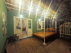 a green room with a wooden table and a door at MOre Home - Ngôi nhà nghĩ dưỡng tại Đà Lạt in Da Lat