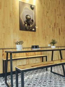 a table and a bench in a room at MOre Home - Ngôi nhà nghĩ dưỡng tại Đà Lạt in Da Lat