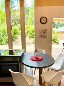 a room with a table and chairs and a clock at Ferienhaus Bachrauschen in Schöna