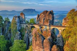 a bridge on top of a rocky mountain at Ferienhaus Bachrauschen in Schöna