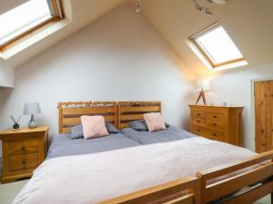 a bedroom with a large bed and two windows at Cute Remarkable quirky 2 Bed House in Derby in Derby