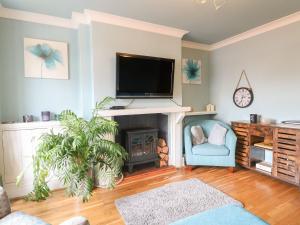 a living room with a tv and a fireplace at Cute Remarkable quirky 2 Bed House in Derby in Derby