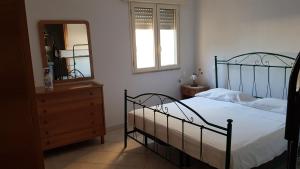 サン・ピエトロ・イン・ベヴァーニャにあるAppartamento San Pietro in Bevagnaのベッドルーム1室(ベッド1台、ドレッサー、鏡付)