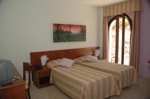Postel nebo postele na pokoji v ubytování Agriturismo L'Arca di Anna Brambilla
