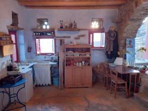a kitchen with a sink and a table in a room at Katerina's Sunset in Panormos