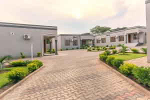 a courtyard of a building with a brick driveway at Luxurious Chimwemwe II - Kat-Onga Apartments in Lusaka