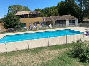 a swimming pool in front of a house at Un duplex pour 4 personne résidence de vacances in Arles