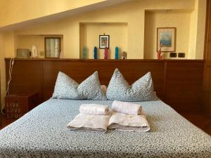 a bedroom with a bed with two towels on it at JFK b & b in Ciampino