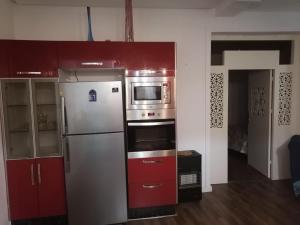 a kitchen with a refrigerator and a microwave at Casa Tligui in Asilah