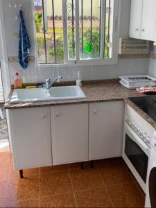 a kitchen with a sink and a stove at Casa Elisa 3 bedrooms 2 bathrooms 4 airco's shared pool in Alcossebre