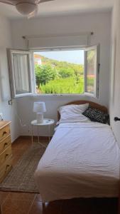 a bedroom with a bed and a large window at Casa Elisa 3 bedrooms 2 bathrooms 4 airco's shared pool in Alcossebre