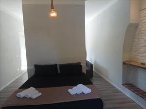 a bedroom with a bed with two towels on it at Lucca&Joy Apartment in Lucca