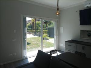 a kitchen with a large sliding glass door to a yard at Lucca&Joy Apartment in Lucca