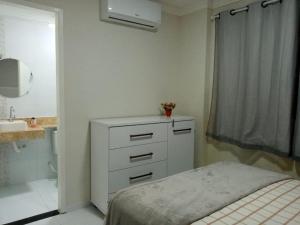 Ένα ή περισσότερα κρεβάτια σε δωμάτιο στο Flat Bem-vindo Bella Maré