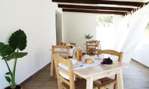a dining room with a table with food on it at Villa Mameli b&b in Rena Majore
