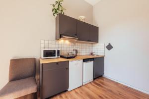 a small kitchen with a counter and a microwave at Mirdzas square in Liepāja